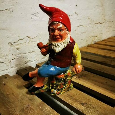 Painted pipe-smoking pixie in ceramic 