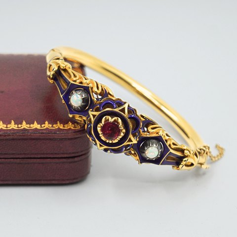 Bangle of 18k gold set with opal, a ruby, and blue enamel, 19th century
