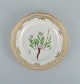 Royal Copenhagen Flora Danica openwork plate in hand-painted porcelain with flowers and gold decoration.