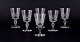 A set of six mouth-blown French white wine glasses in crystal glass. Faceted cut.