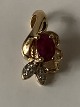 Pendant 14 carat gold, with a red ruby ​​and embedded diamonds.