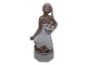 Rare Royal Copenhagen figurineBalinese woman with two pigs by Arno Malinowski, with overglaze painting and gold details.