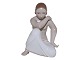 Rare Royal Copenhagen figurineWoman kneeling by Arno Malinowski, with overglaze painting and gold details.