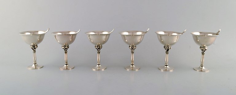 Harald Nielsen for Georg Jensen. A set of six cocktail glasses and six cocktail picks in hammered sterling silver. Dessin 479 A and 68 A.