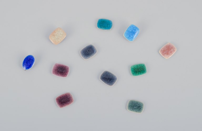 Ole Bjørn Krüger (1922-2007), Danish sculptor and ceramicist.Eleven unique brooches/ear clips in glazed stoneware in various shades.